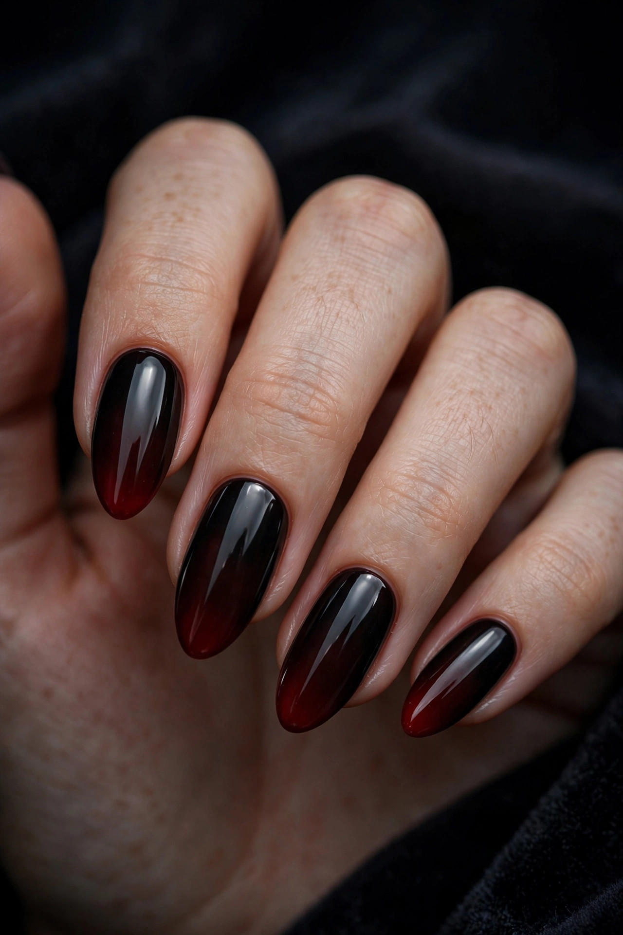 Teen hand with dark nails and dark cherry red gradient tip nail art